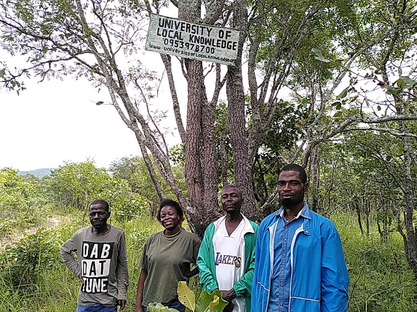 Some of our forest professors at the sign of the University of Local Knowledge. 